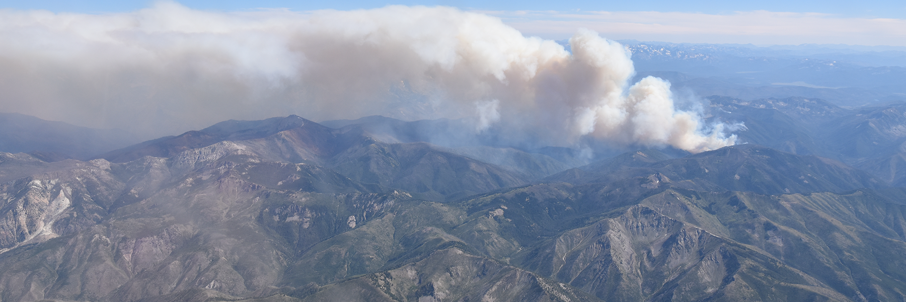 Wildfire smoke over mountains, link to article